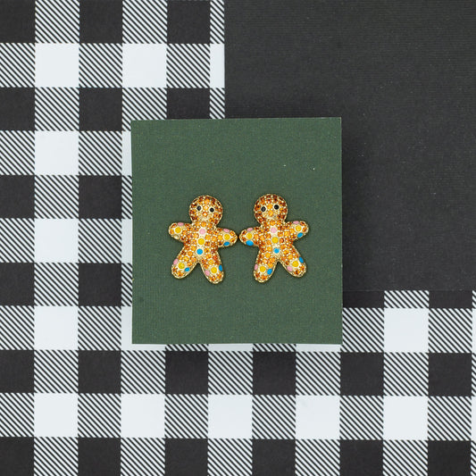 Gingerbread man earrings on a green card with a black and white checkered background
