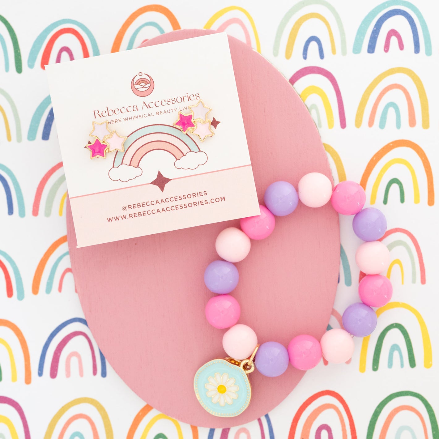 Colorful beaded necklace with a Rebecca Accessories card on a rainbow-patterned background