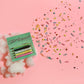 Card with 'Customer Service' text on a pink background with cotton and sprinkles
