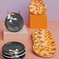 A set of ceramic plates featuring a whimsical cartoon cat design, displayed on minimalist pedestals against a pastel purple and peach background. The plates include a black cat curled up and a yellow-orange tabby cat with an open mouth.